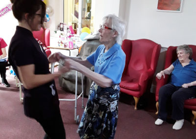 Resident and staff member dancing together at Lulworth House Residential Care Home