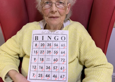 Female resident with her winner bingo card
