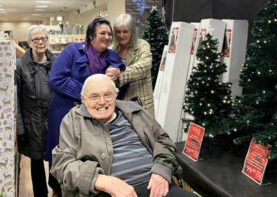 Lulworth staff and residents by the Christmas trees in a shop