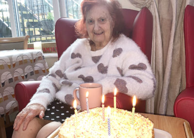Lady resident with her birthday cake at Lulworth House