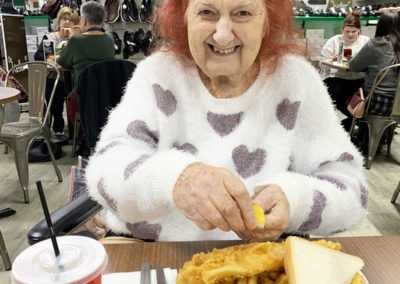 Lady resident with a large plate of fish and chips