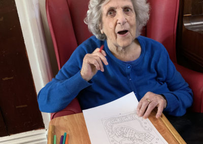 Lulworth House lady resident doing some Christmas colouring