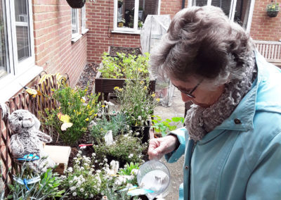 Lady residents watering the garden at Lulworth House 2