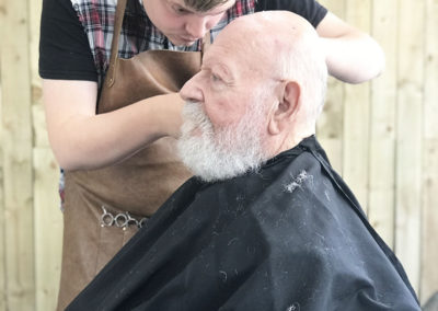 Male resident having his hair cut at the barbers