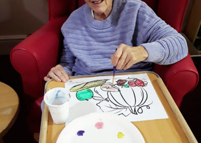 Lulworth lady resident painting a seasonal picture