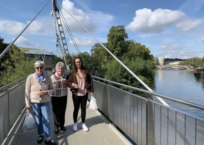 Residents and staff walking to Maidstone, posing on a bridge
