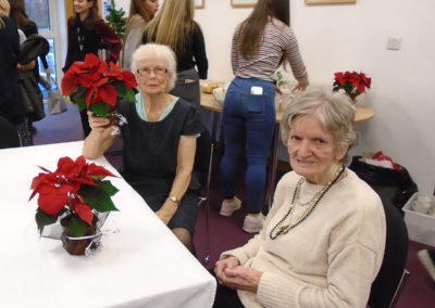 Two Lulworth House Residential Care Home ladies sitting at a table on a visit to Invicta School