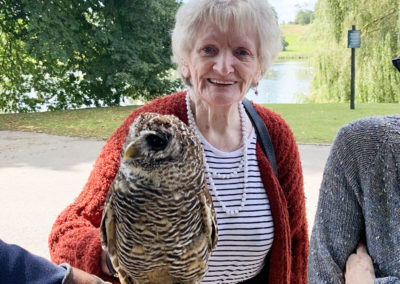 Lady resident admiring an owl in the grounds of Leeds Castle