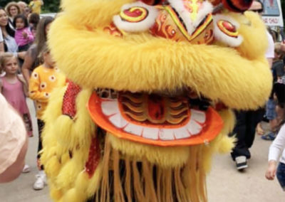 Bright yellow Chinese Dragon with dancers inside