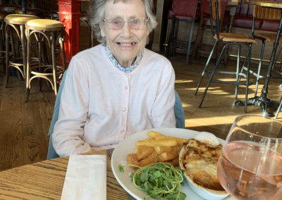 Lulworth lady resident enjoying a lasagne and chips at a local pub