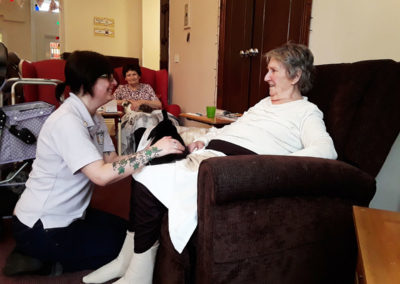 Lady residents enjoying cuddles with a rabbit on their laps