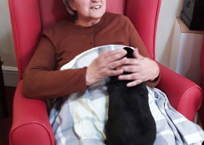 Female resident cuddling rabbit on her lap