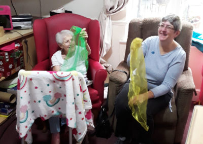 Residents playing with scarfs together at Lulworth House