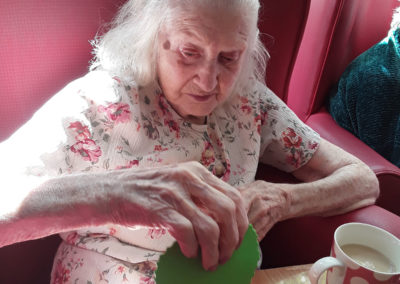 Lady resident doing sensory crafts at Lulworth House Residential Care Home
