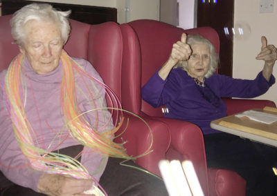 Residents at Lulworth House touching fibre optic strands as part of a sensory exploration session