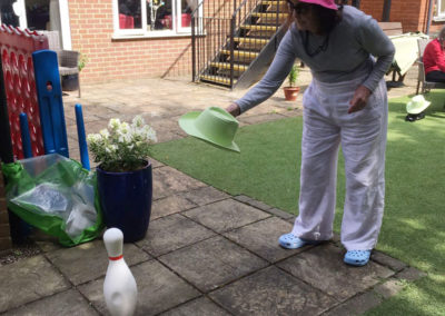 A Lulworth House lady resident playing hat skittles