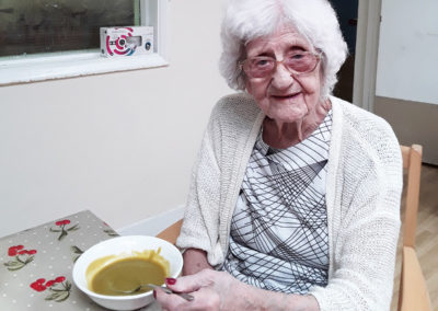Lady resident enjoying home made soup at Lulworth House