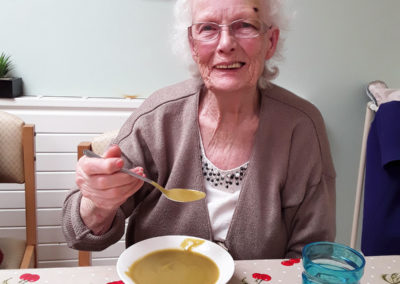 Lady resident enjoying soup at Lulworth House