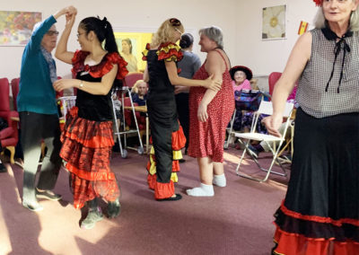Residents and staff dancing at a Spanish party at Lulworth House