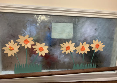Paper daffodil decorations displayed on a wall