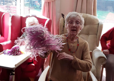 A Lulworth House resident waving a pom pom during a Music For Health workshop