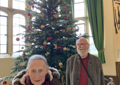 Two Lulworth House Residential Care Home residents with a Christmas tree inside Leeds Castle
