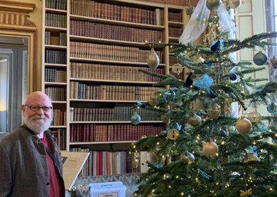 A Lulworth House gentleman resident with a Christmas tree inside Leeds Castle