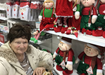 Lulworth House lady resident in a shop looking at Christmas decorations