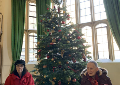 Two Lulworth House Residential Care Home ladies with a Christmas tree inside Leeds Castle