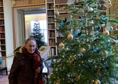 A Lulworth House lady resident with a Christmas tree inside Leeds Castle