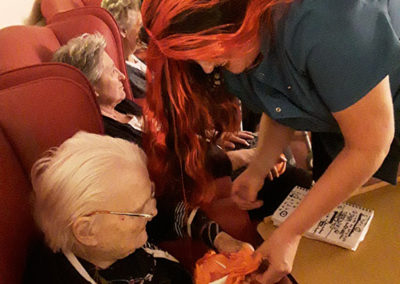 Lulworth House staff interact with residents during a spooky poem puppet show
