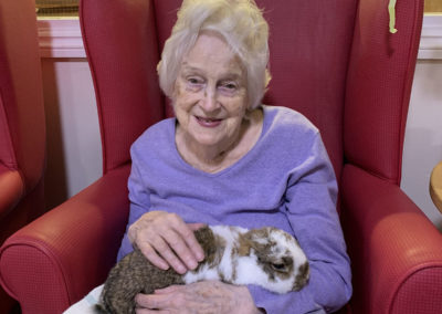 Ladies at Lulworth House Residential Care Home enjoying cuddles with a rabbit (4 of 6)