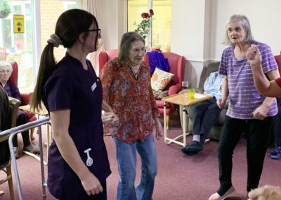 Residents dancing together during a pub afternoon at Lulworth House