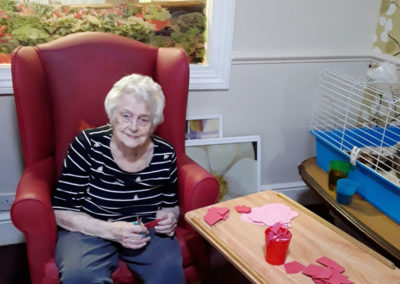 Lady doing Valentine's crafts at Lulworth House Residential Care Home