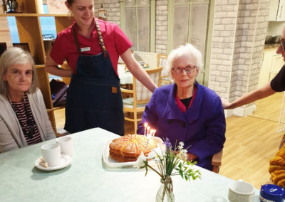 Lady resident at Lulworth receiving her birthday cake