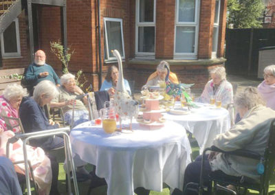 Lulworth House residents enjoying a tea party in the garden