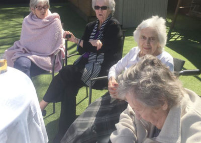 Lulworth House residents enjoying a tea party in the garden in the sunshine