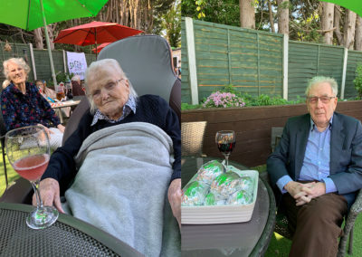 Lulworth House Residential Care Home residents sat in the garden with a glass of wine