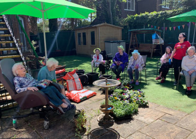 Ladies at Lulworth House Residential Care Home sitting in the garden enjoying the sunshine
