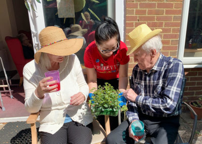 Lulworth House Residential Care Home residents sitting in the sunny garden with a drink