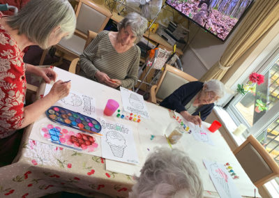 A group of Lulworth House residents painting pictures of ice creams