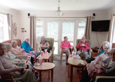 A group of Lulworth House residents having a movie morning with popcorn