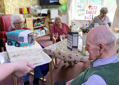 Resident receiving a camper van birthday cake
