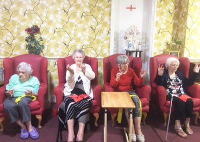 Lulworth House Residential Care Home residents doing a seated yoga class together