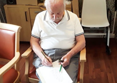 Lulworth House Residential Care Home gentleman resident sketching with a pencil