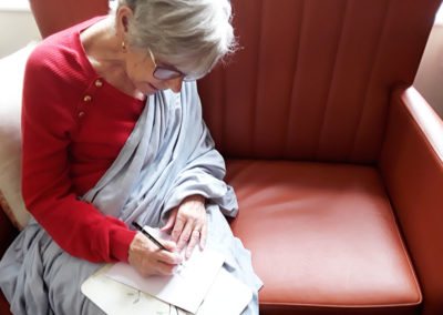 Lulworth House Residential Care Home lady resident sketching with a pencil