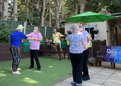 Residents in the garden at Lulworth House dancing at a party