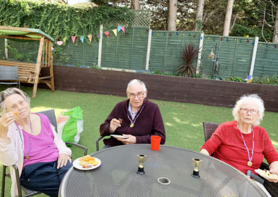 Lulworth House Residential Care Home residents sitting together in the garden