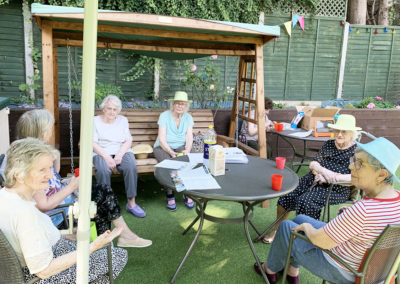 Lulworth House Residential Care Home ladies in the garden chatting about the Weekly Sparkle