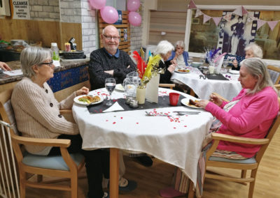 Residents enjoying a themed birthday party at Lulworth House Residential Care Home